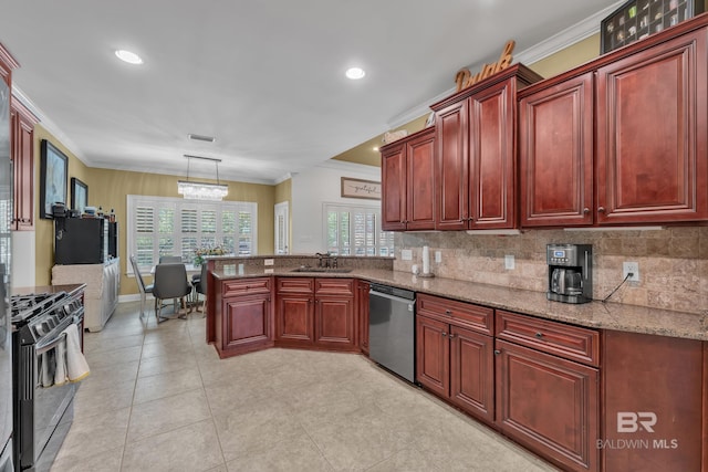 24085 Trowbridge Ct, Daphne, AL 36256 - kitchen featuring appliances with stainless steel finishes, dark brown cabinets, a peninsula, a sink, and plenty of natural light