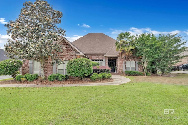 24085 Trowbridge Ct, Daphne, AL 36256 - view of front of home with a front yard, brick siding, and a shingled roof