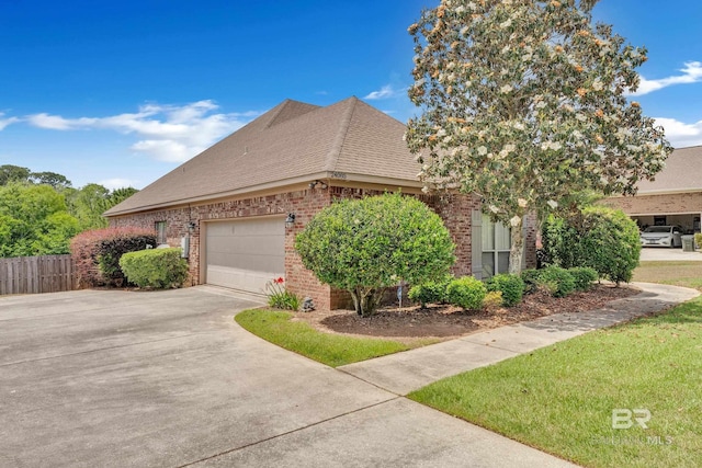 24085 Trowbridge Ct, Daphne, AL 36256 - view of home's exterior featuring driveway, brick siding, an attached garage, and a shingled roof