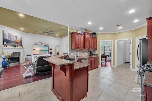 24085 Trowbridge Ct, Daphne, AL 36256 - kitchen featuring appliances with stainless steel finishes, reddish brown cabinets, crown molding, light tile patterned flooring, and a peninsula