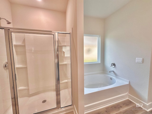 bathroom featuring separate shower and tub and hardwood / wood-style floors