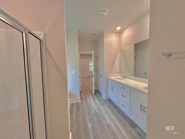 bathroom with hardwood / wood-style floors and vanity