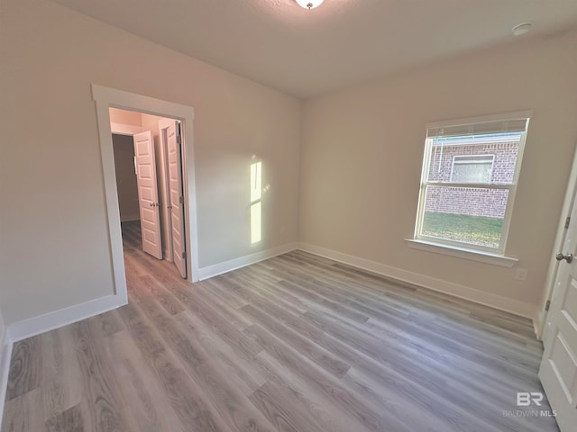 empty room with light hardwood / wood-style flooring