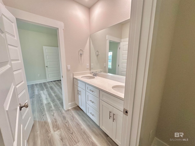 bathroom featuring hardwood / wood-style flooring and vanity