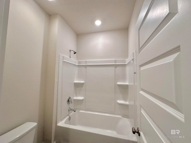 bathroom featuring bathing tub / shower combination and toilet