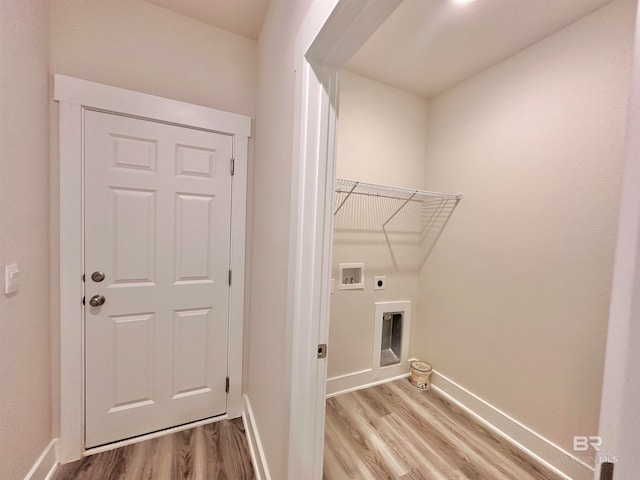 clothes washing area featuring hookup for an electric dryer, light wood-type flooring, and washer hookup