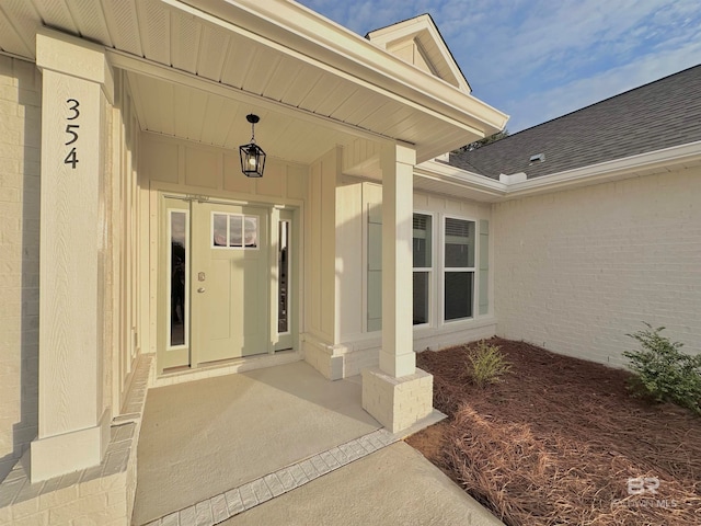 view of exterior entry with covered porch