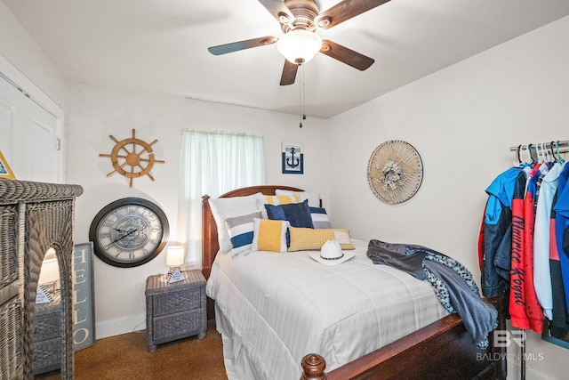 carpeted bedroom with a ceiling fan and baseboards