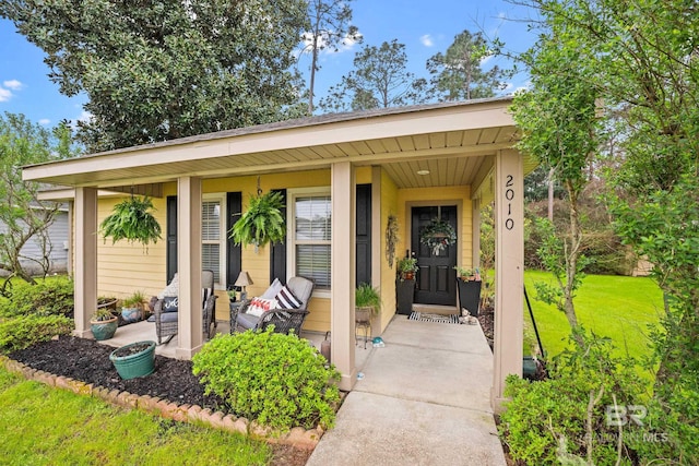 property entrance featuring a yard and a porch