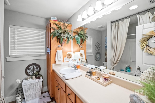 bathroom with vanity, a shower with shower curtain, and toilet