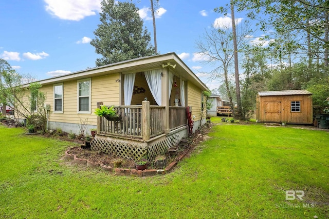 back of property with an outdoor structure, a yard, and a shed