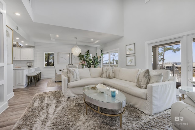 living room with light wood-style flooring, a wealth of natural light, and recessed lighting