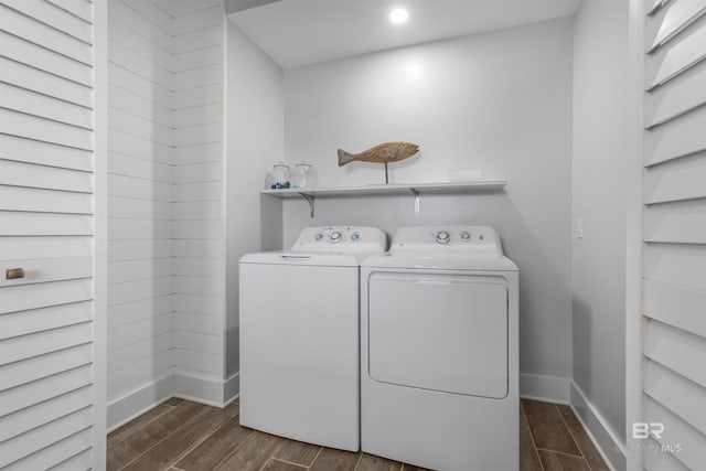 laundry room featuring separate washer and dryer, baseboards, and dark wood finished floors