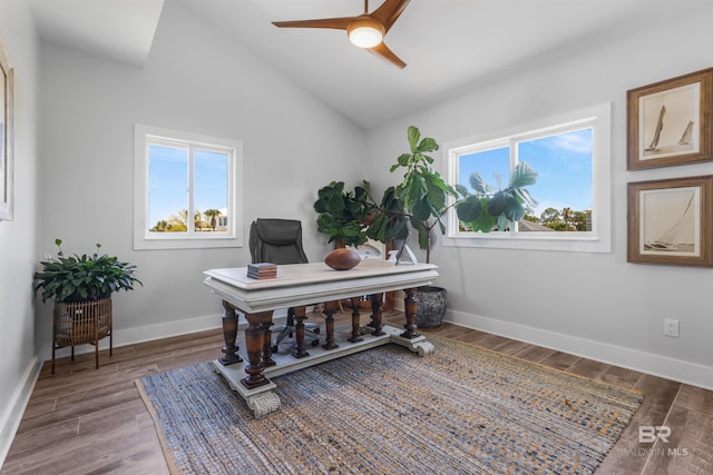office area with baseboards, vaulted ceiling, a ceiling fan, and wood finished floors