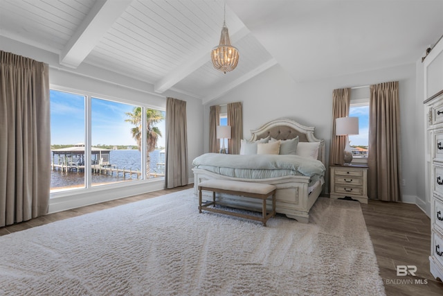 bedroom featuring multiple windows, a chandelier, wood finished floors, and lofted ceiling with beams