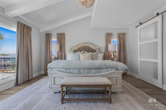 bedroom featuring multiple windows, wood finished floors, and lofted ceiling with beams