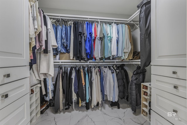 spacious closet featuring marble finish floor