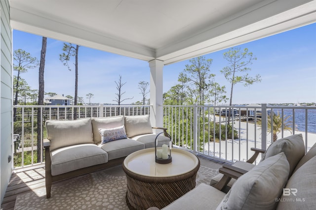 balcony with a water view and an outdoor hangout area