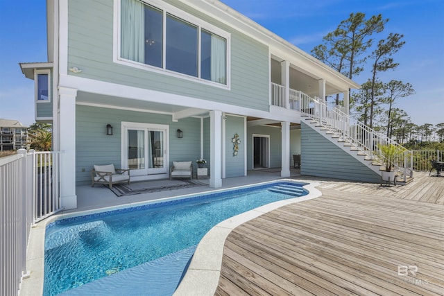 back of house with stairway, a fenced in pool, and a patio