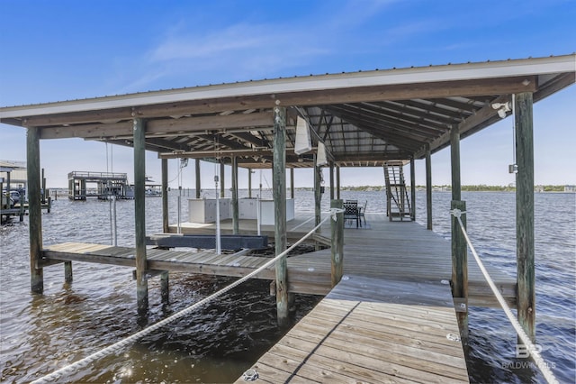 view of dock with boat lift and a water view