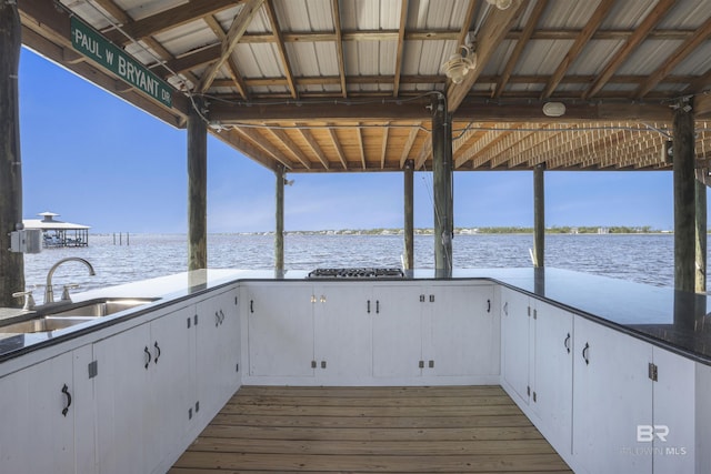 dock area featuring a water view and a sink