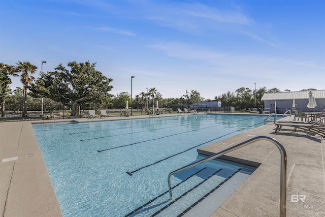 community pool featuring a patio and fence