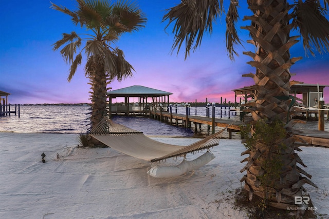 view of dock featuring a water view and a gazebo