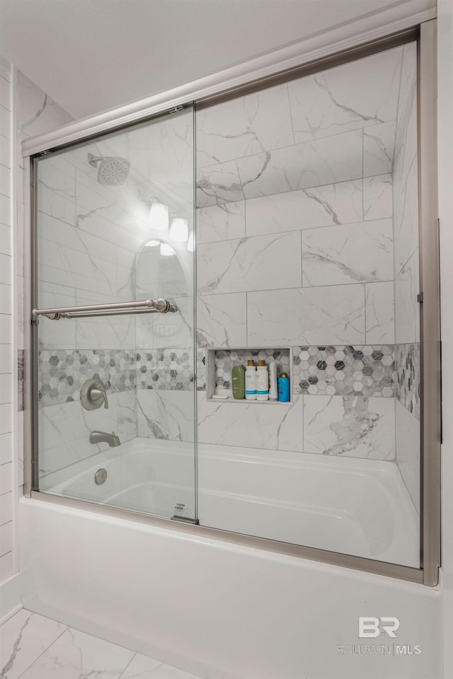 full bath with shower / bath combination with glass door and marble finish floor
