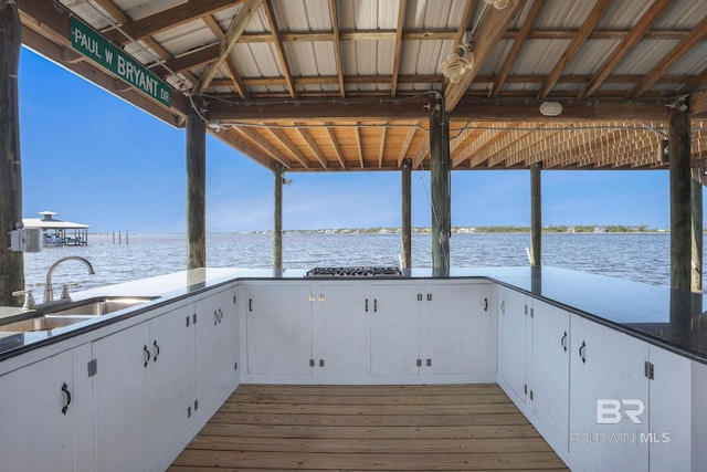 dock area featuring a water view and a sink