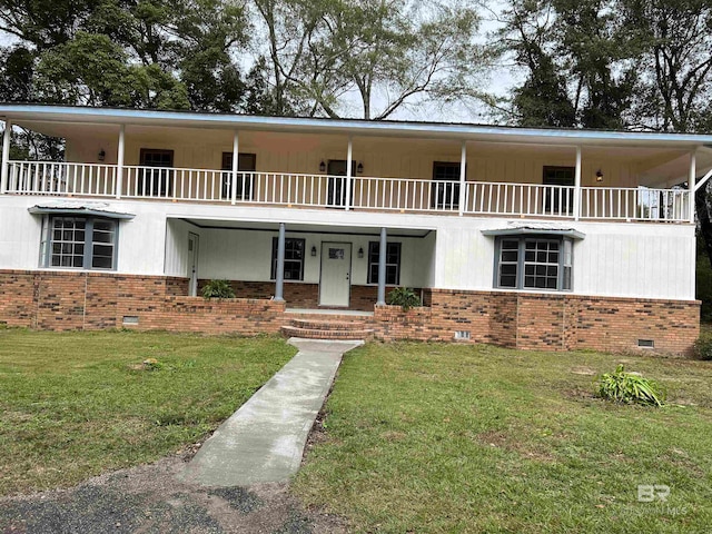 view of front facade featuring a porch, a balcony, and a front lawn