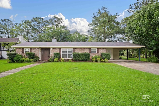 517 Simms Dr, Saraland, AL 36571 - view of front of home with brick siding, a front yard, an attached carport, driveway, and a chimney