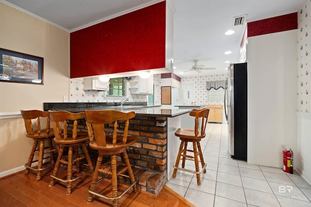 517 Simms Dr, Saraland, AL 36571 - bar area featuring freestanding refrigerator, a ceiling fan, ornamental molding, and light tile patterned floors