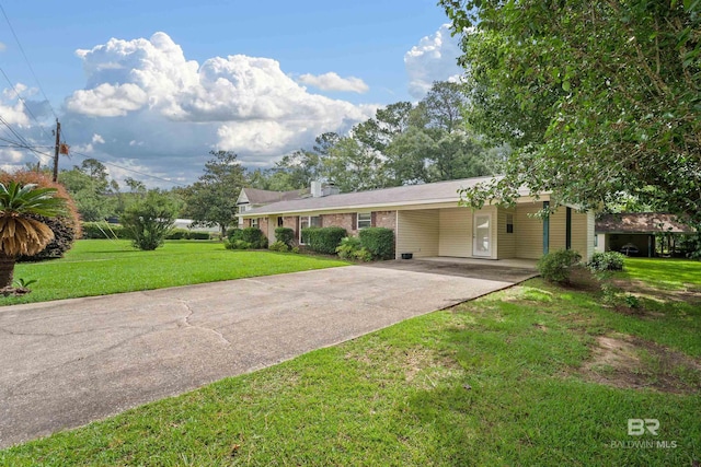 517 Simms Dr, Saraland, AL 36571 - single story home with concrete driveway, a front lawn, a carport, and a chimney
