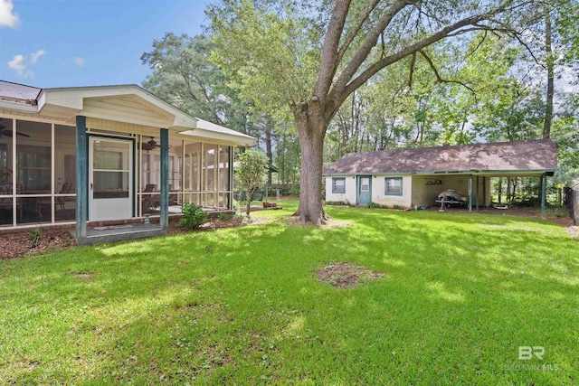 517 Simms Dr, Saraland, AL 36571 - view of green lawn with a sunroom, a carport, and a ceiling fan