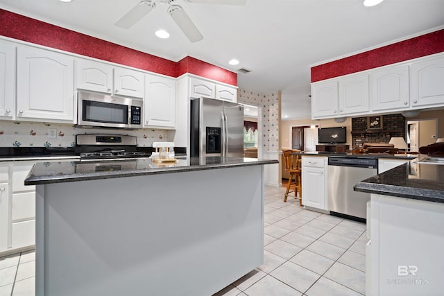 517 Simms Dr, Saraland, AL 36571 - kitchen with stainless steel appliances, light tile patterned flooring, white cabinetry, ceiling fan, and recessed lighting