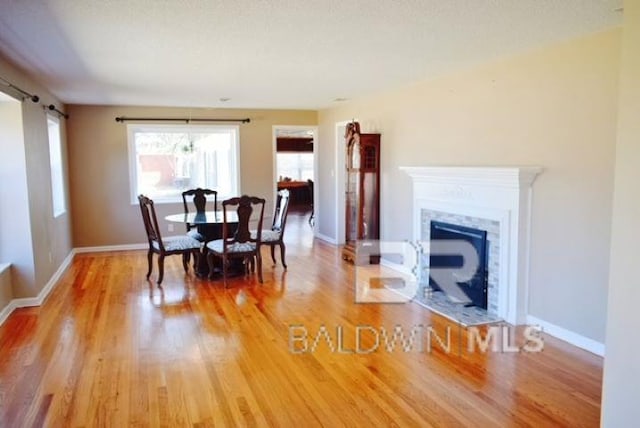 dining room with hardwood / wood-style flooring and a textured ceiling