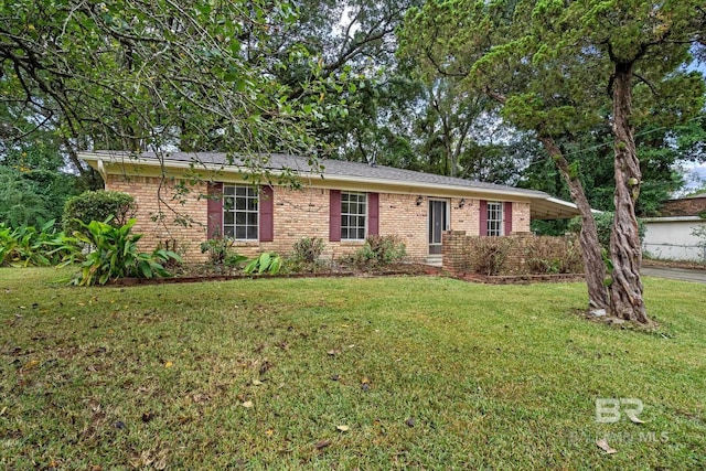 ranch-style house featuring brick siding and a front yard