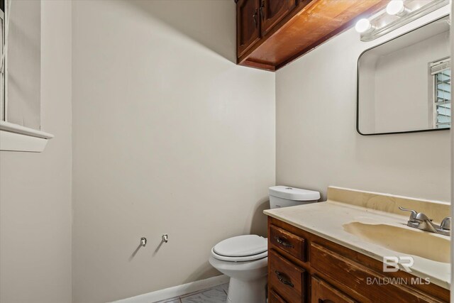 bathroom featuring toilet and vanity