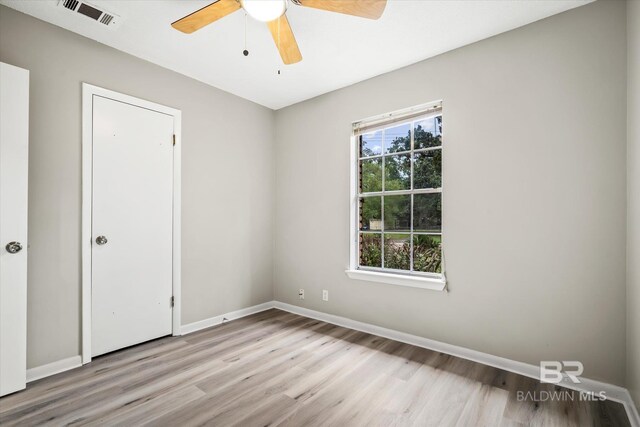 spare room with ceiling fan and light hardwood / wood-style floors