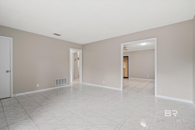 spare room with visible vents and baseboards