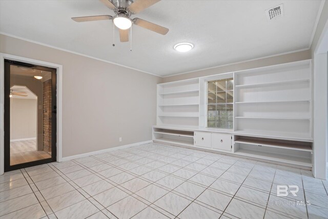 tiled spare room featuring crown molding, built in features, and ceiling fan