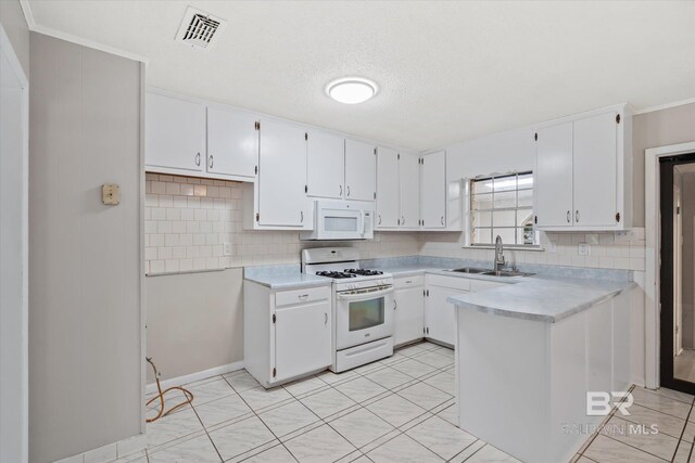 kitchen featuring white cabinets, white appliances, backsplash, and sink