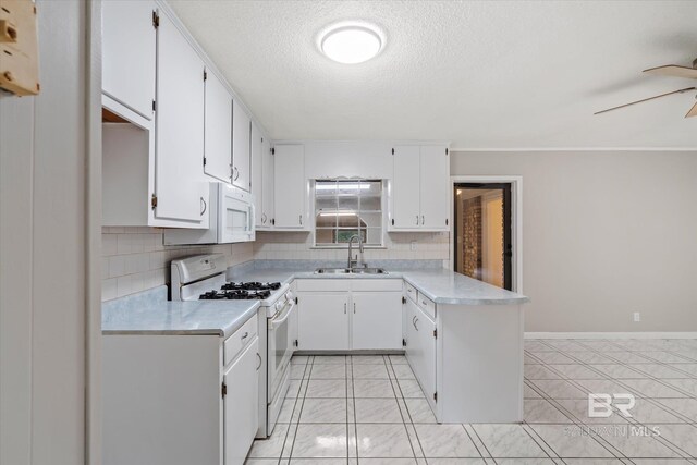 kitchen featuring white appliances, light tile patterned floors, sink, ceiling fan, and white cabinets