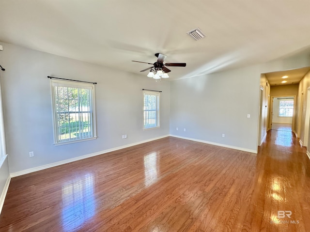 unfurnished room featuring ceiling fan and hardwood / wood-style flooring