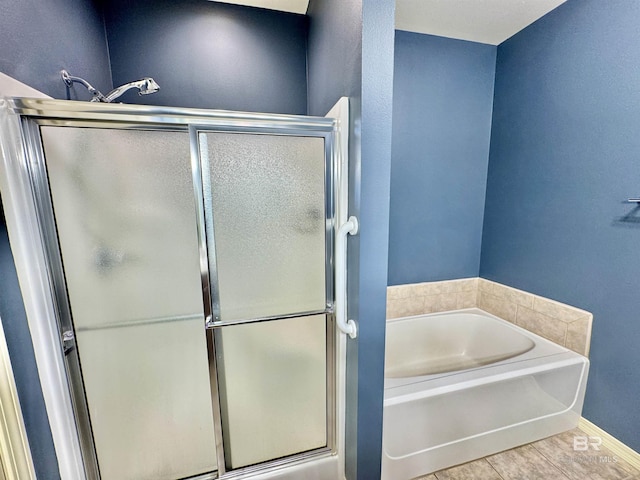 bathroom featuring shower with separate bathtub