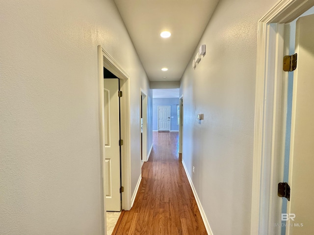 hall with light hardwood / wood-style floors