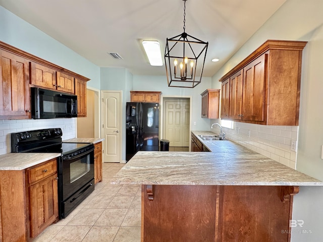 kitchen featuring backsplash, kitchen peninsula, pendant lighting, a breakfast bar, and black appliances