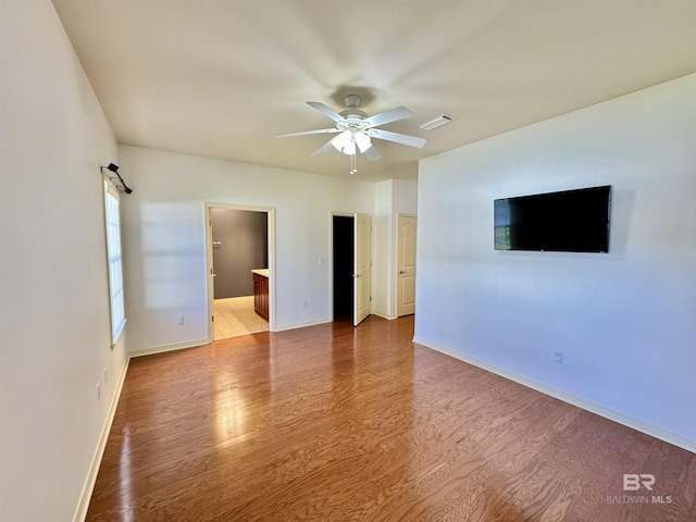 spare room with hardwood / wood-style floors and ceiling fan