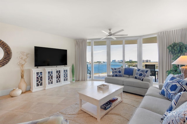 tiled living room featuring floor to ceiling windows and ceiling fan