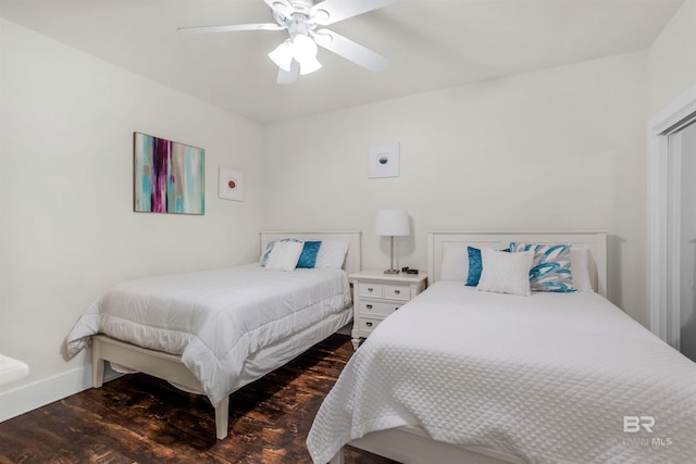 bedroom with ceiling fan and dark wood-type flooring